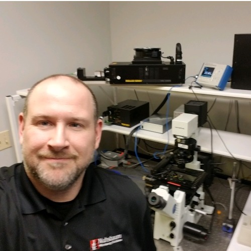 Chris Huppenbauer with microscopes