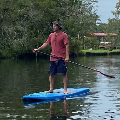 man on blue paddleboard